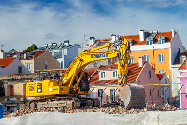 Excavator moving debris on urban construction site