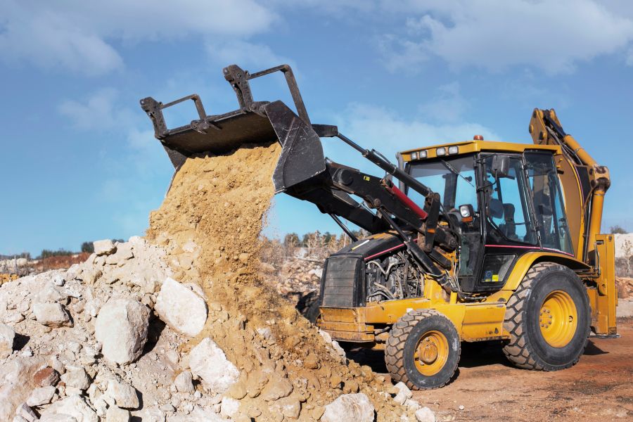 Heavy excavator digging foundation in daylight construction project