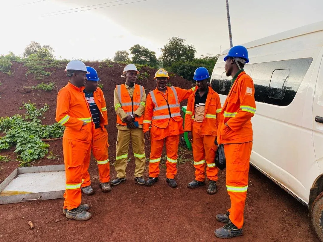 Vision Logistics field team in safety gear at a project site in Uganda